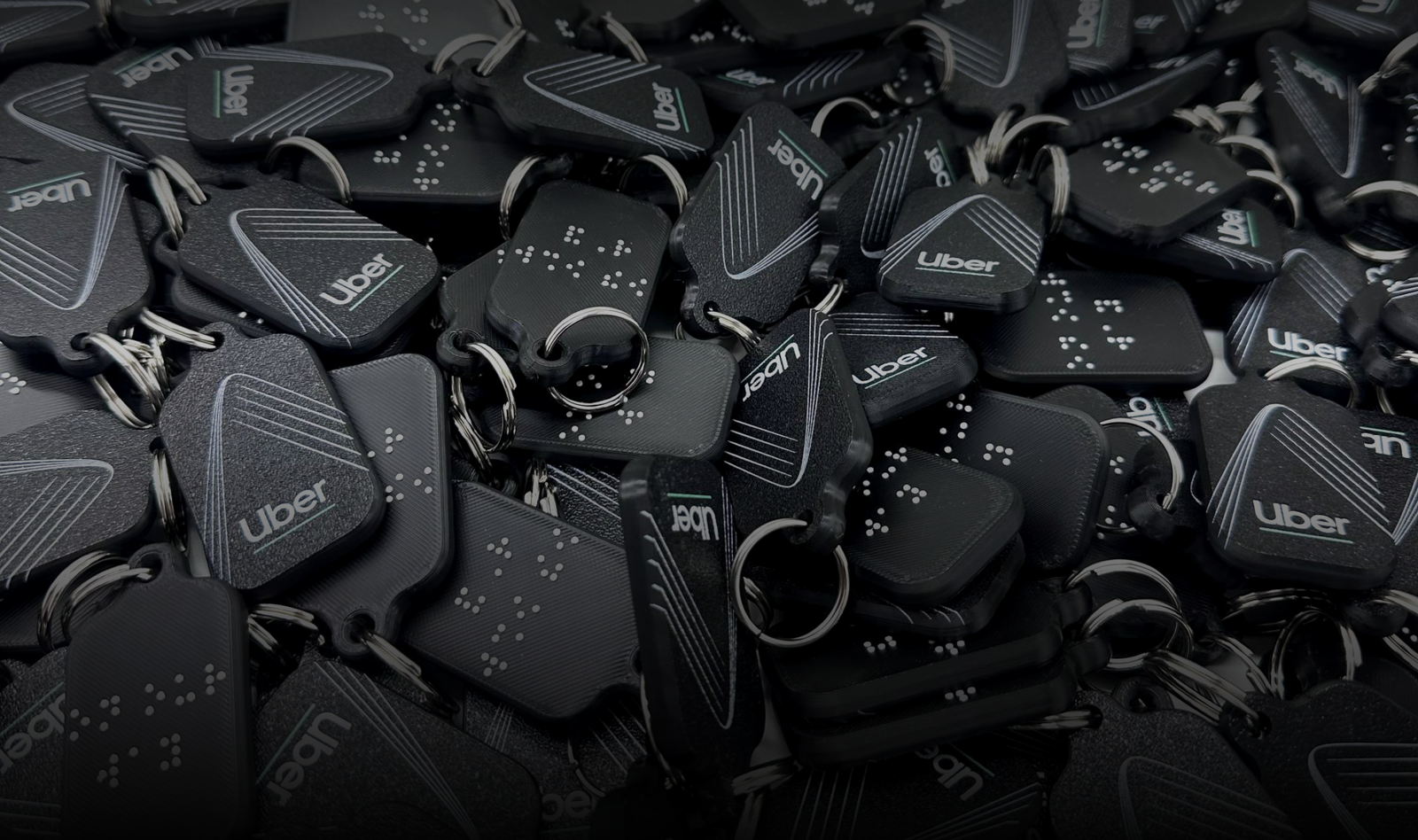 Keychains with braille text made by Miloh for Uber